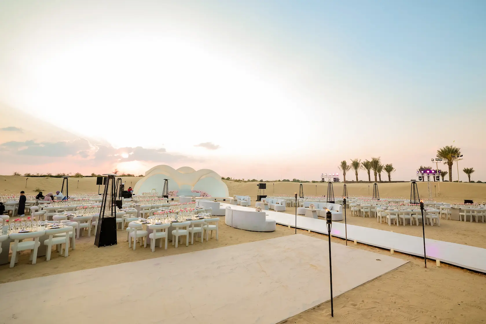 Grand luxury wedding venue ballroom in Dubai with crystal chandeliers and elaborate floral installations